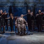 2. A scene from Amadeus, Lucian Msamati as Antonio Salieri with members of Southbank Sinfonia. Image by Marc Brenner