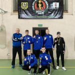 Shopping woman holding grey bag isolated on dark background in black friday holiday