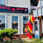 Modern bathroom with glass shower and marble tile.