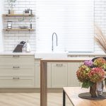 Bouquet of autumn flowers on the background of the interior of a modern kitchen in a Scandinavian style.